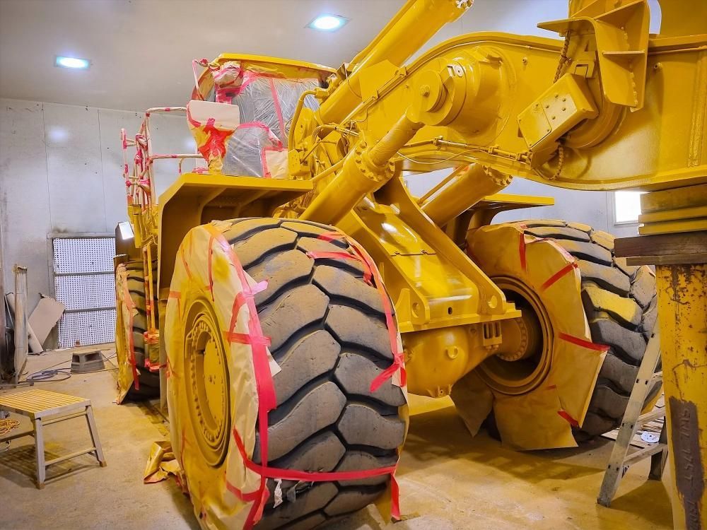 Yellow Heavy Machinery, Likely a Loader, Inside a Building — Tincone Pty Ltd in Paget, QLD