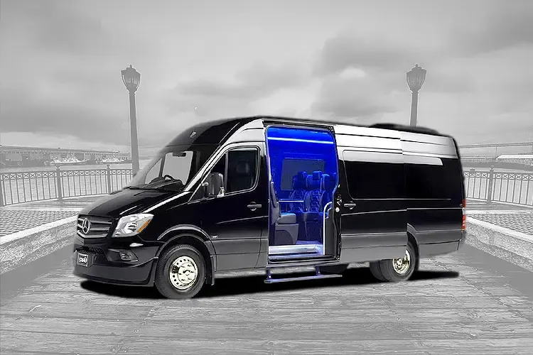 A black van with the door open is parked on the side of the road.