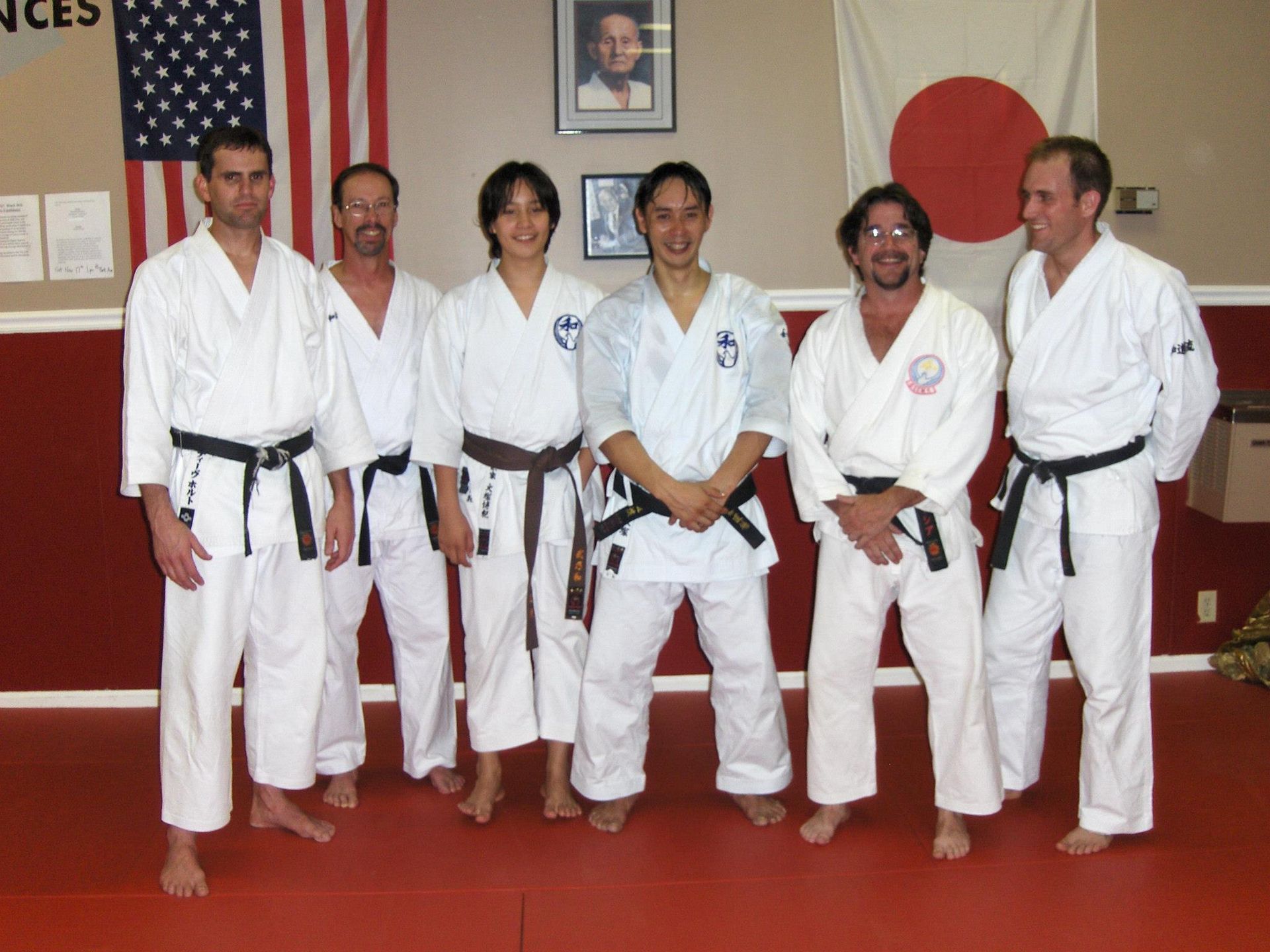a group of men in karate uniforms pose for a picture