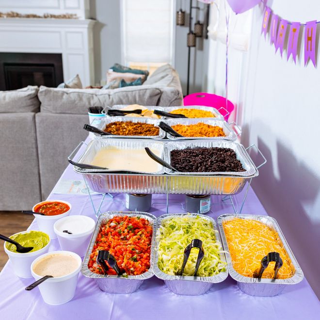 a mexican food catering buffet with a banner that says happy birthday on it