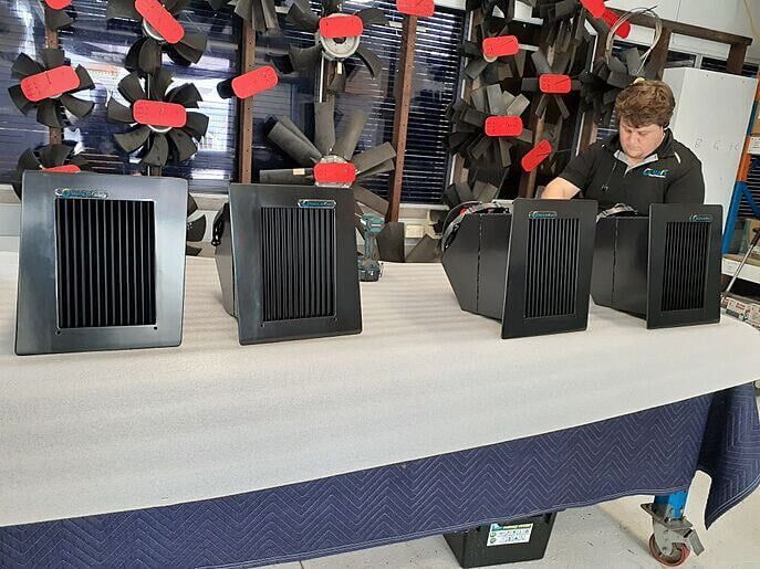 Custom designed air intake grilles with DC compact fans face on where you can see the angle of the frame surround