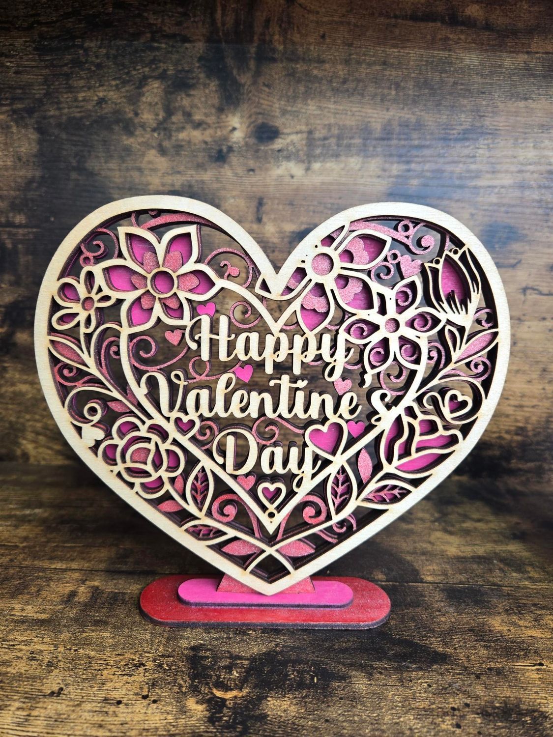 Wooden heart-shaped Valentine's Day decoration with flowers and 