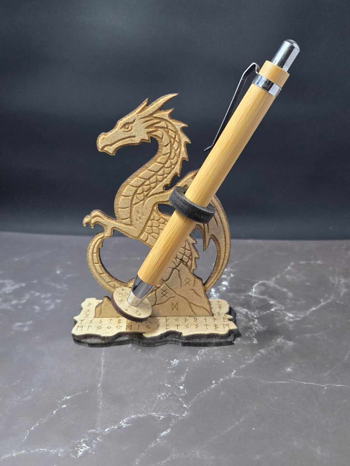 Wooden dragon pen holder with a pen.