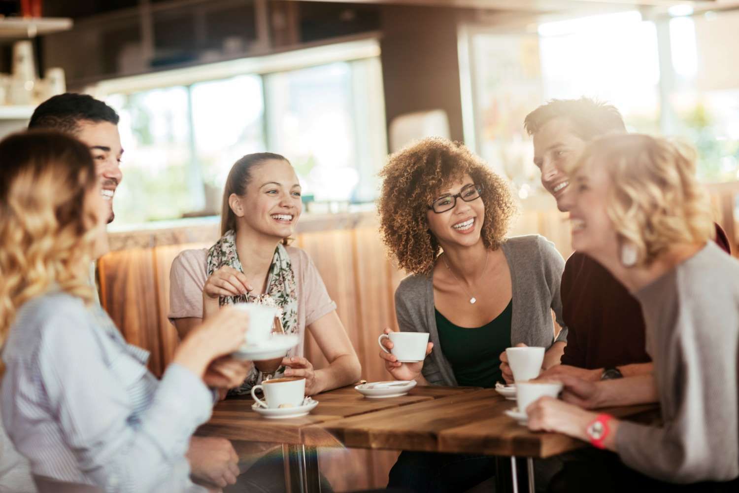 Group Of People Having Coffee Together At A Cafe In The City — Eleos Support Services In Lavington, NSW