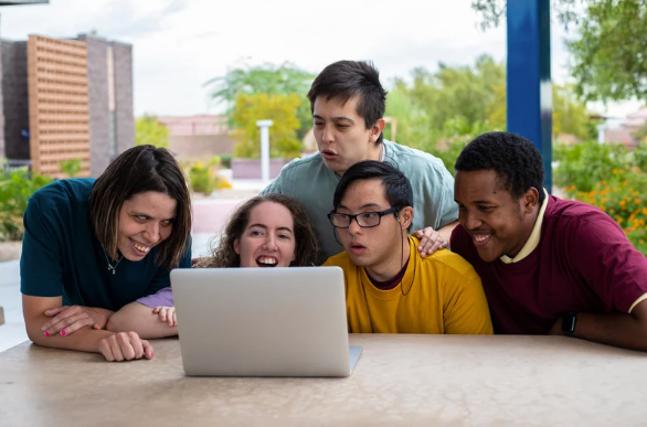 A Group of Young People Looking At A Laptop — Eleos Support Services In Lavington, NSW