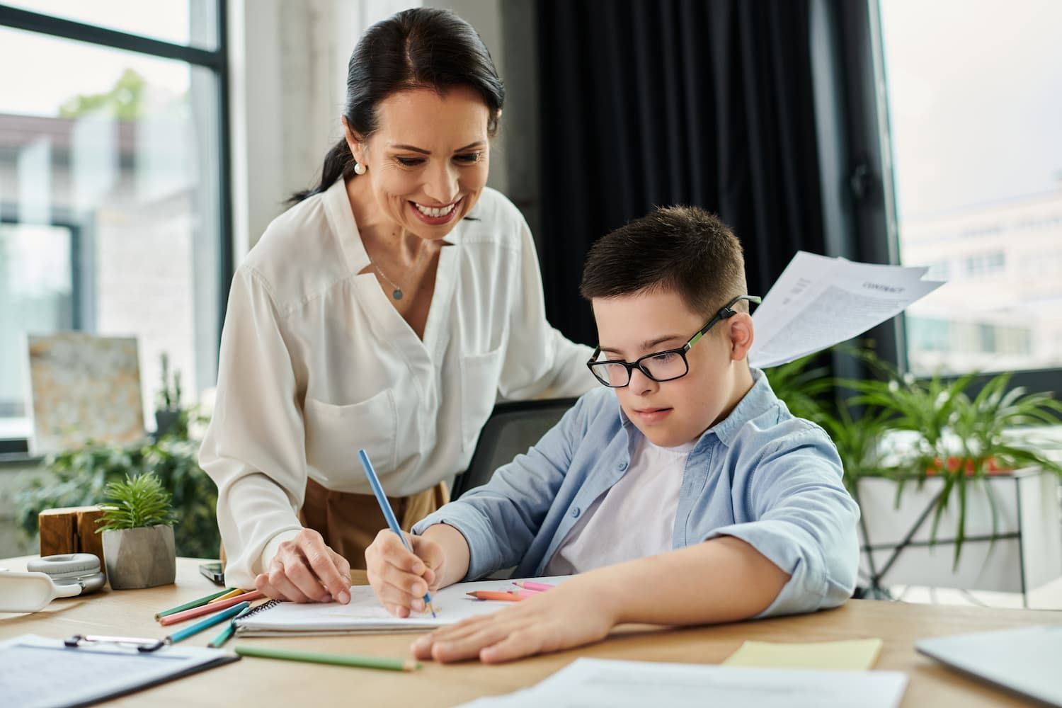 A Woman is Helping a Boy With His Homework — Eleos Support Services In Lavington, NSW