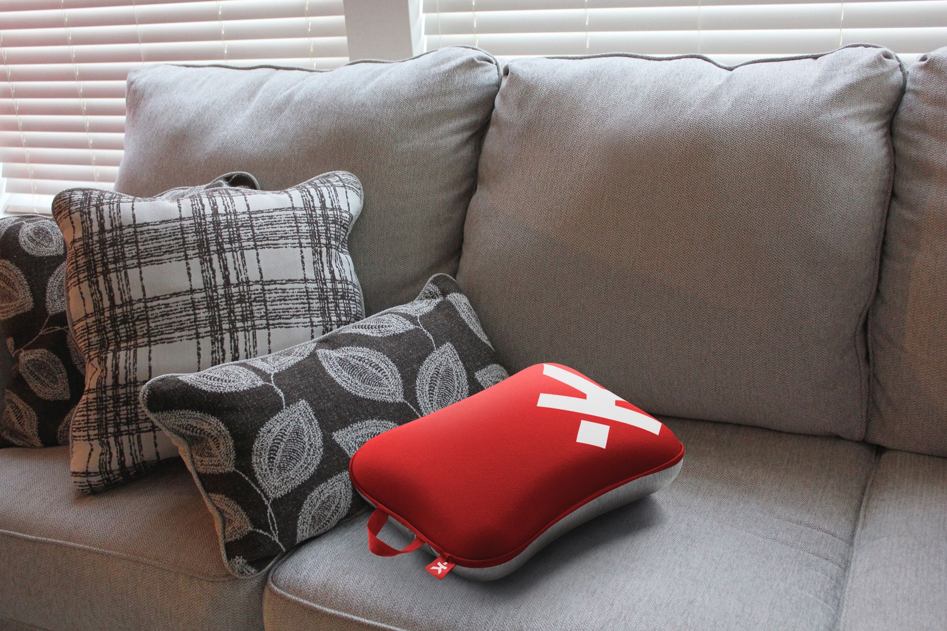 Red Mini Skross Pillow on sofa at home