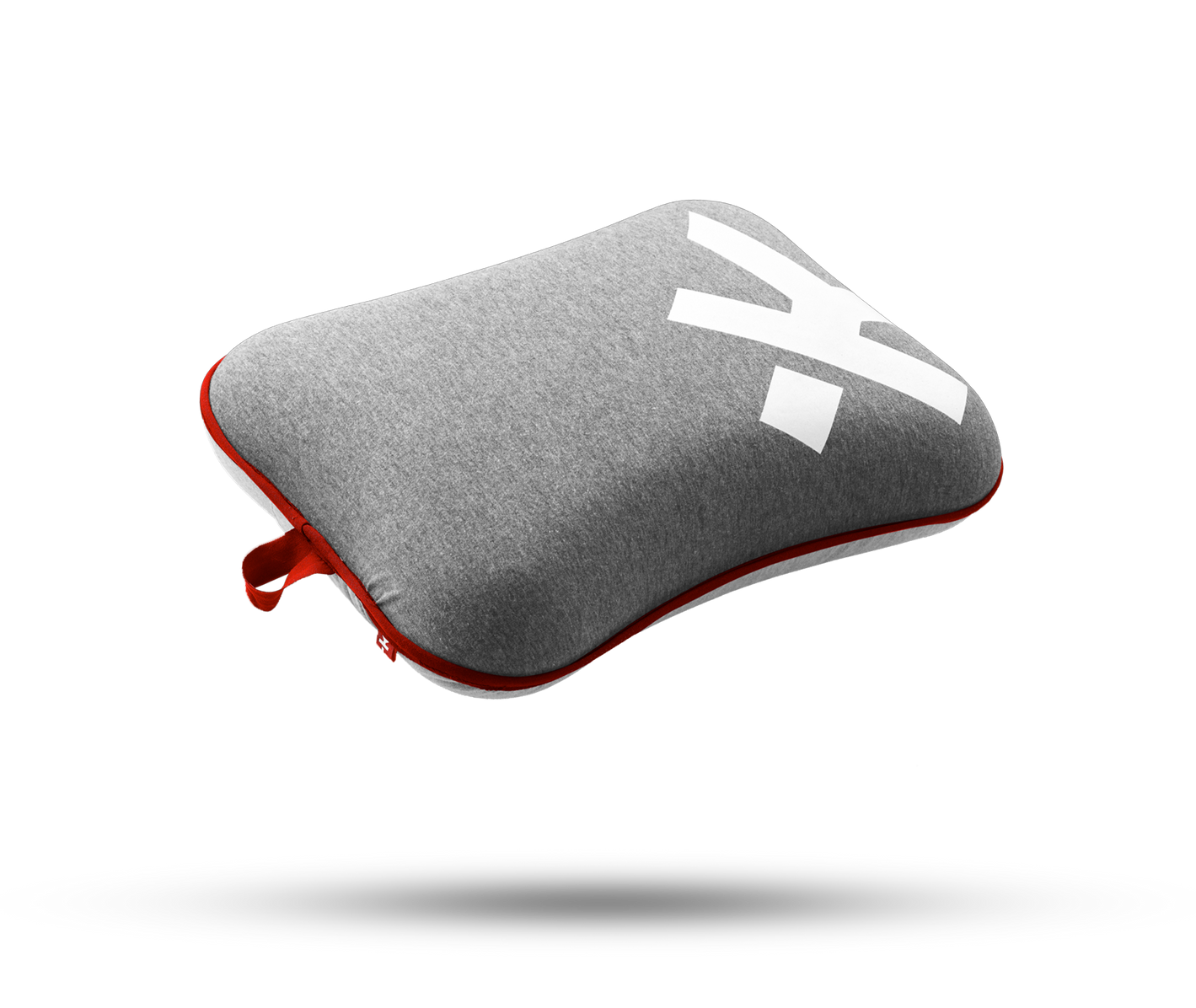 A grey pillow with the letter x on it