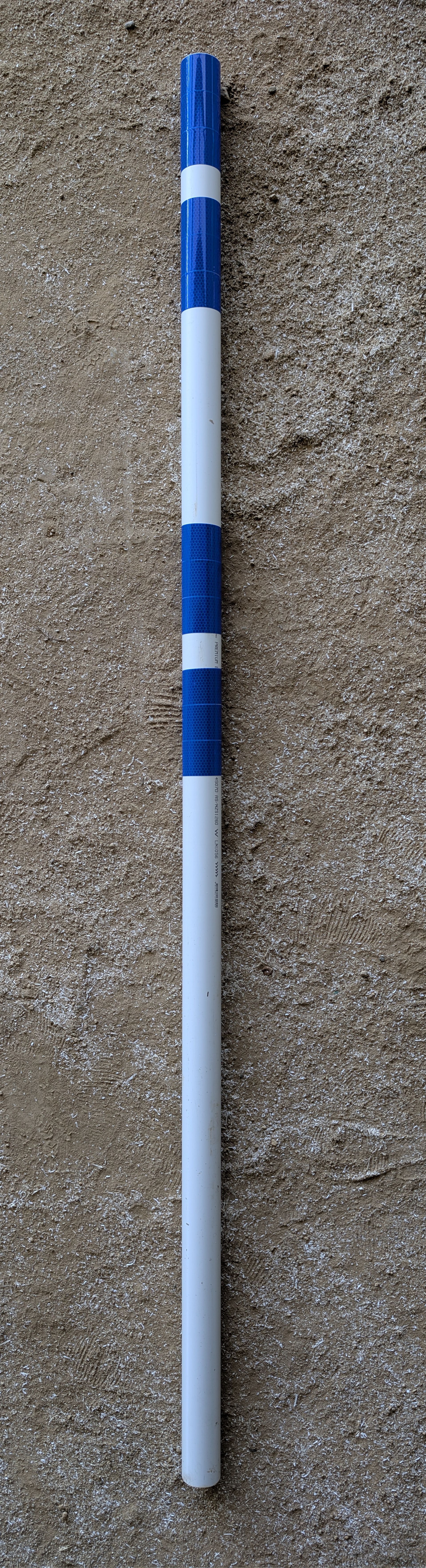 A white cane for a visually impaired person with alternating blue and white striped sections at the top.