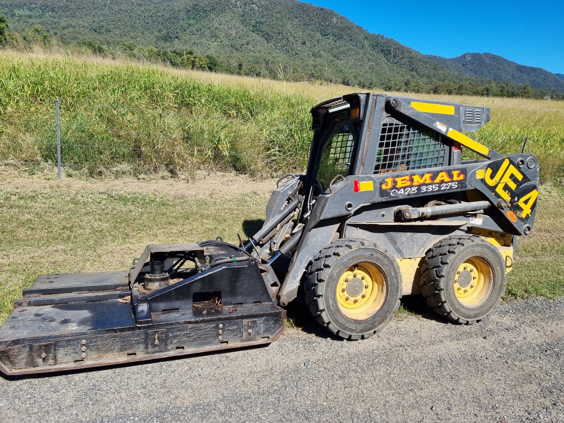 Skid Steer With Brush Cutter Attachment — Jemal Enterprises In Finch Hatton, QLD