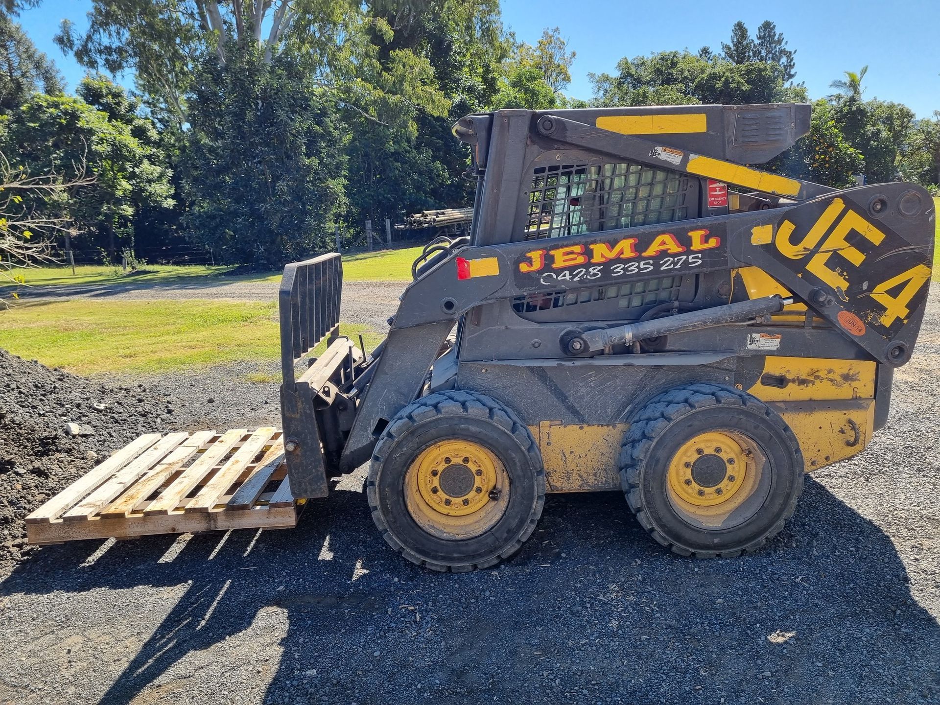 Skid Steer Loader With Pallet Forks, Yellow and Black — Jemal Enterprises In Finch Hatton, QLD
