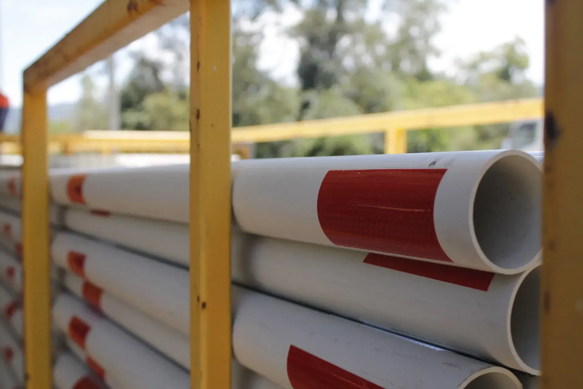 White Pvc Pipes Stacked, With Red Bands — Jemal Enterprises In Finch Hatton, QLD