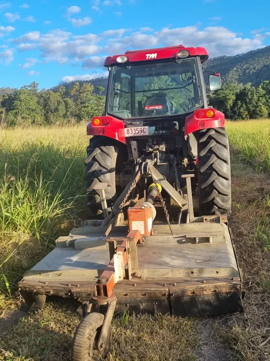 Red Tractor With a Mower in a Field — Jemal Enterprises In Finch Hatton, QLD