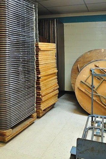 Warehouse Filled With Tables and Chairs 