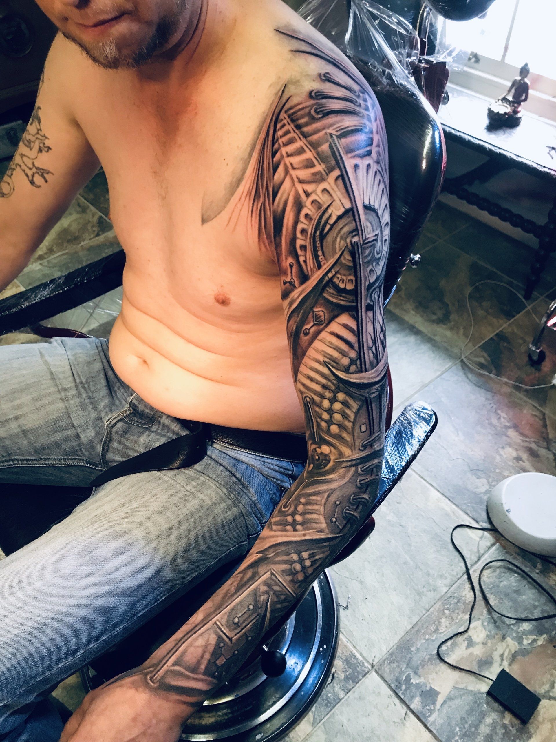 man sitting down with sleeve tattoo