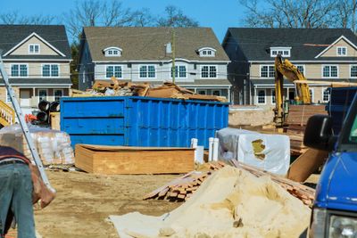 Snow Removal — Construction Site with Blue Dumpster Full of Debris in Rochester Hills, MI
