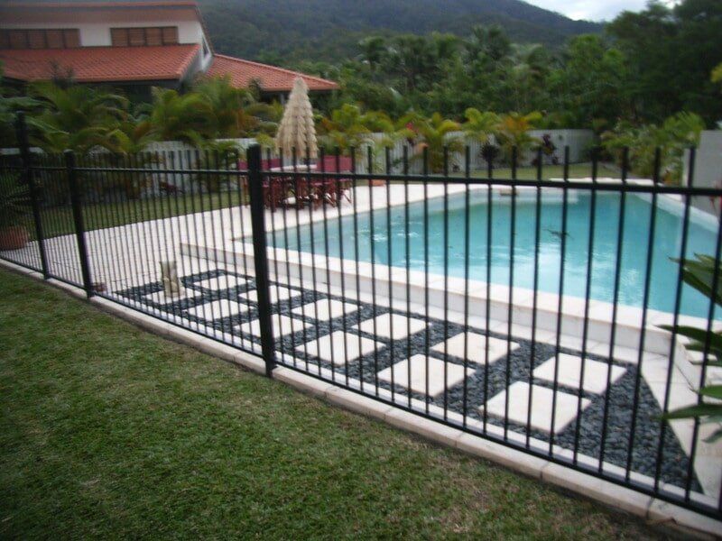 Swimming Pool With Fence — Landscaping and Paving Service in Trinity Beach, QLD