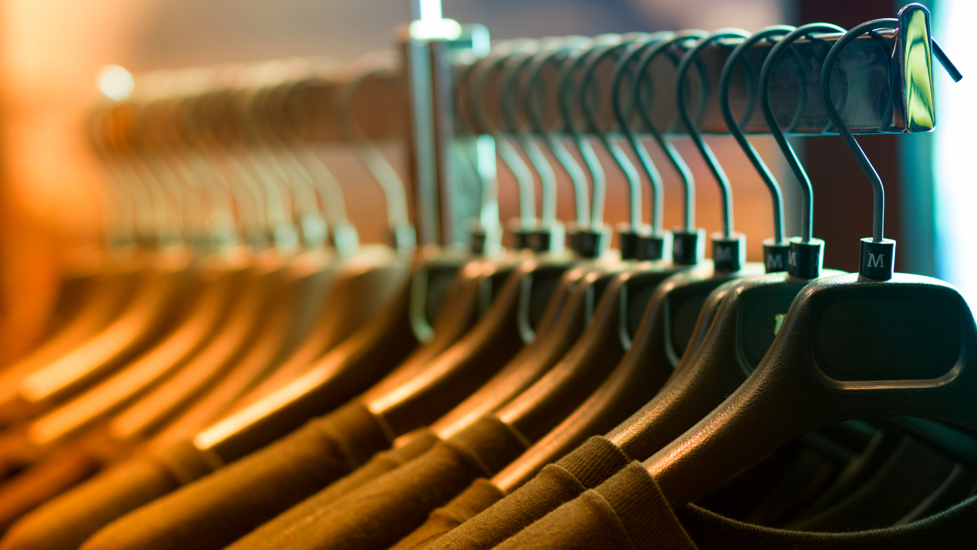 A row of clothes hanging on a rack in a store
