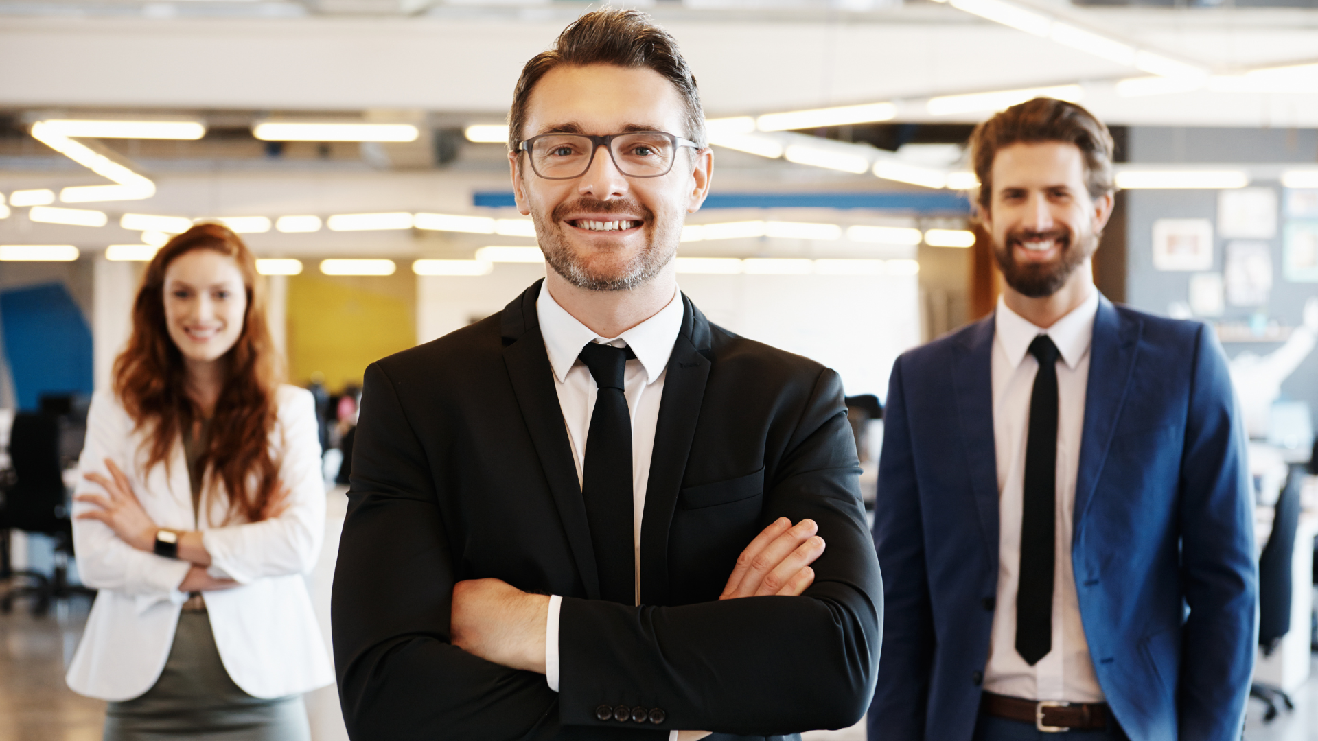 A group of business people are posing for a picture in an office.