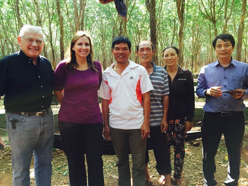 A group of people posing for a picture in a forest