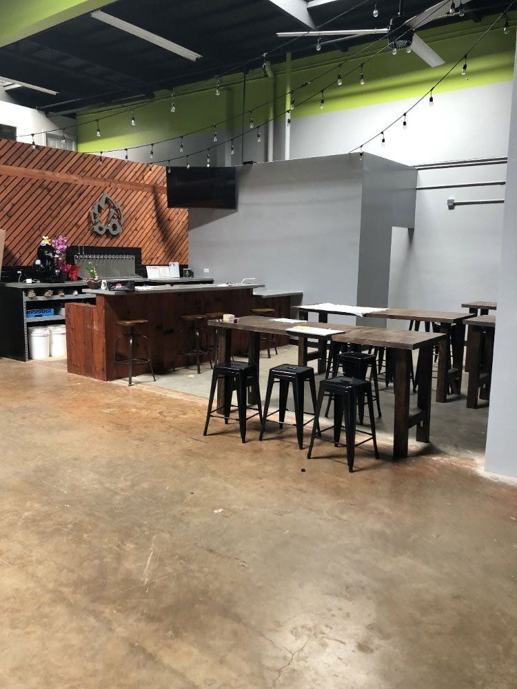 A large room with tables and stools in it