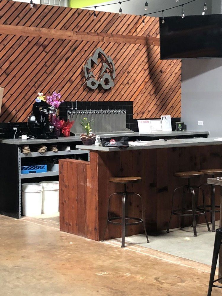 A kitchen with a wooden counter top and stools