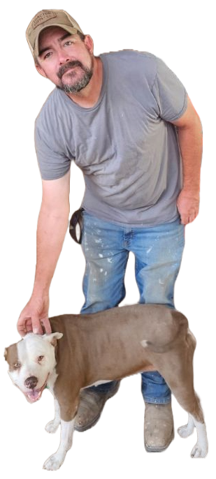 Man in a gray T-shirt and cap bending beside a brown-and-white dog on a white background