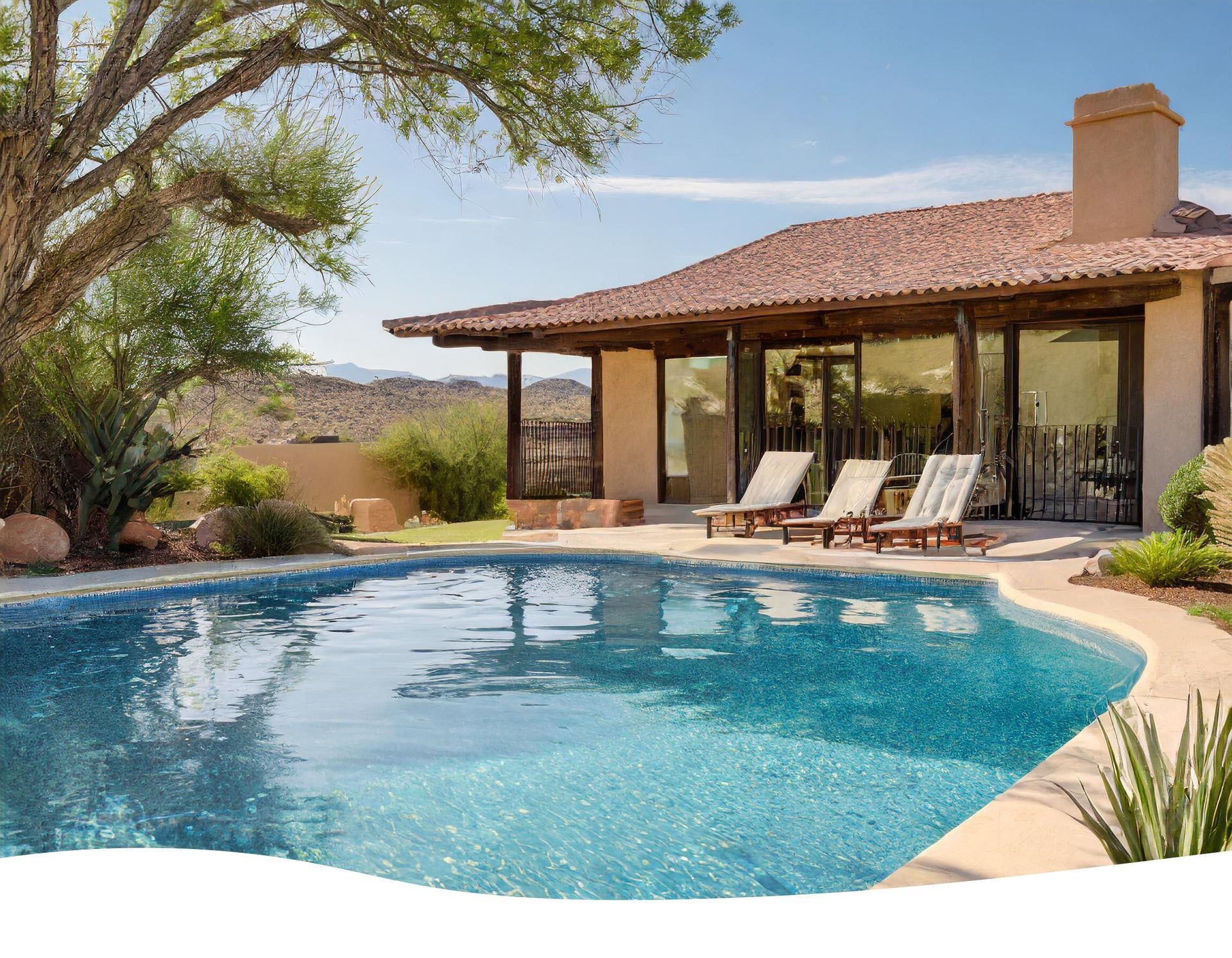 Backyard patio with a blue swimming pool, lounge chairs, and a stucco house under a tiled roof