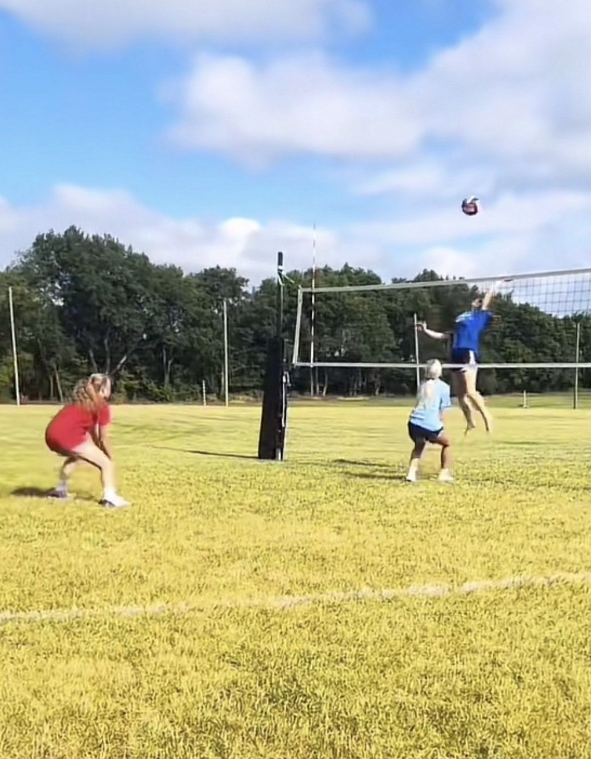A golf ball by the hole on green grass.