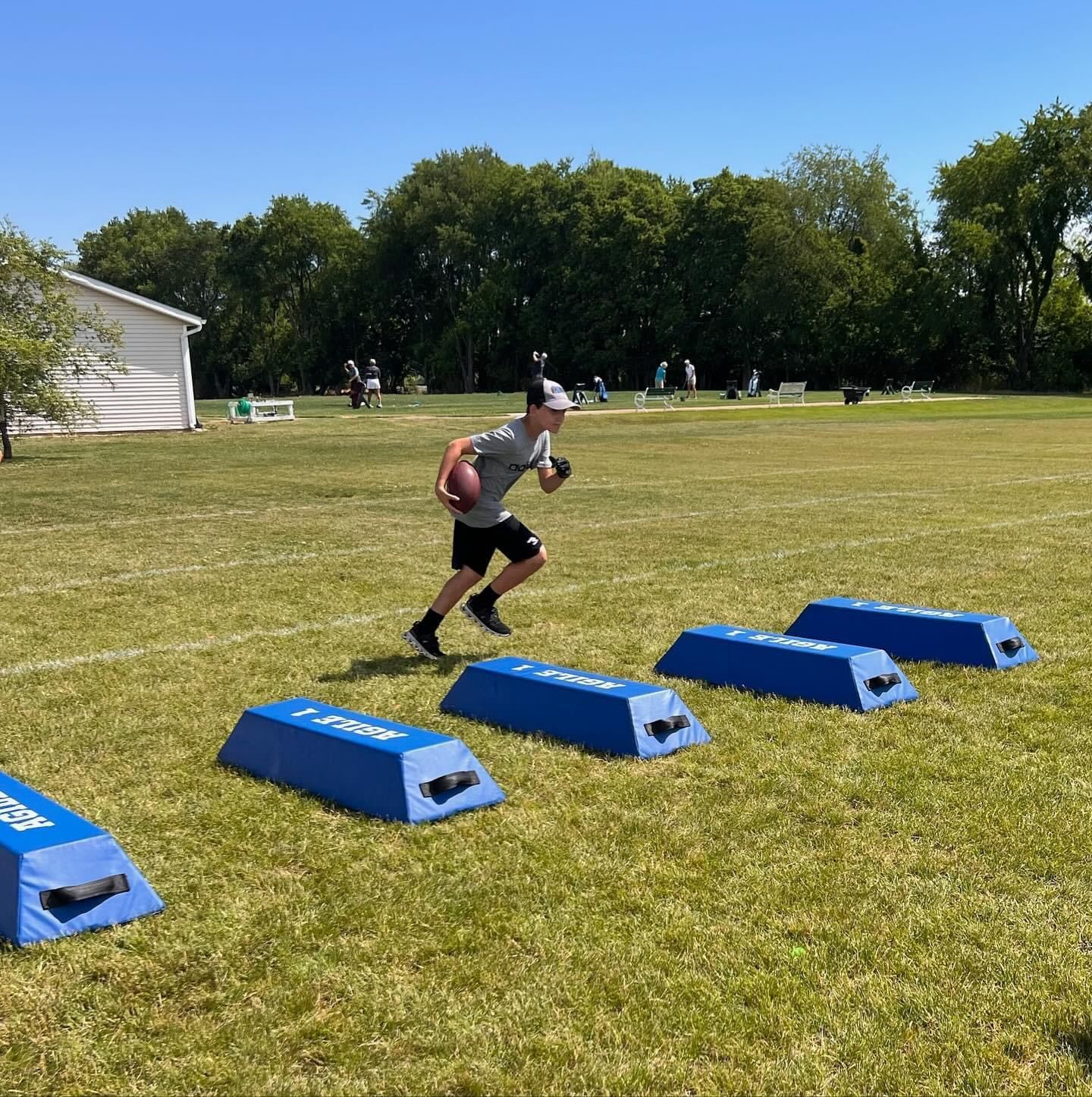 A man is running with a football in a field