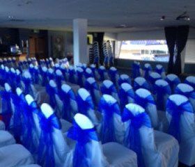 white chair covers with blue bows