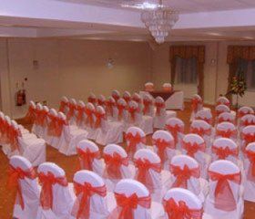 white chair covers with red bows