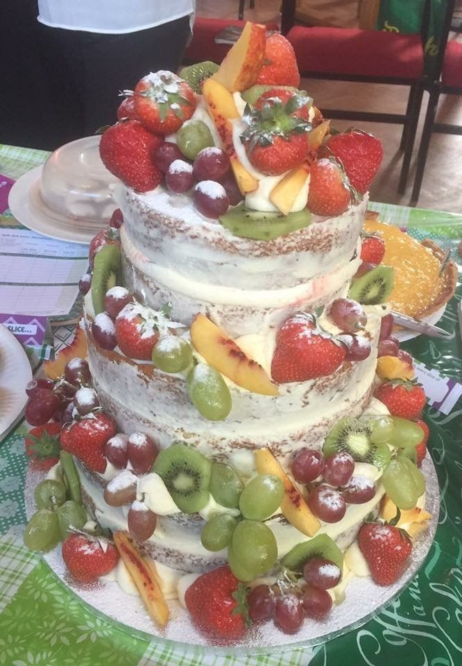 'naked' 4 tier cake decorated with fruit