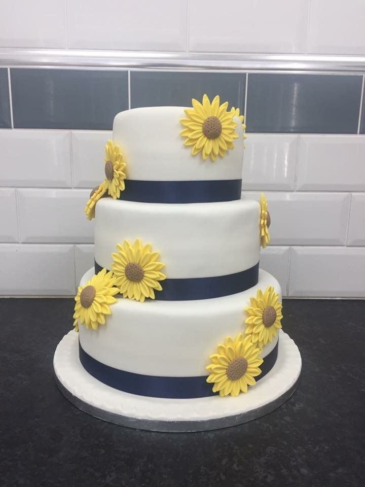 3 tier cake with yellow flowers