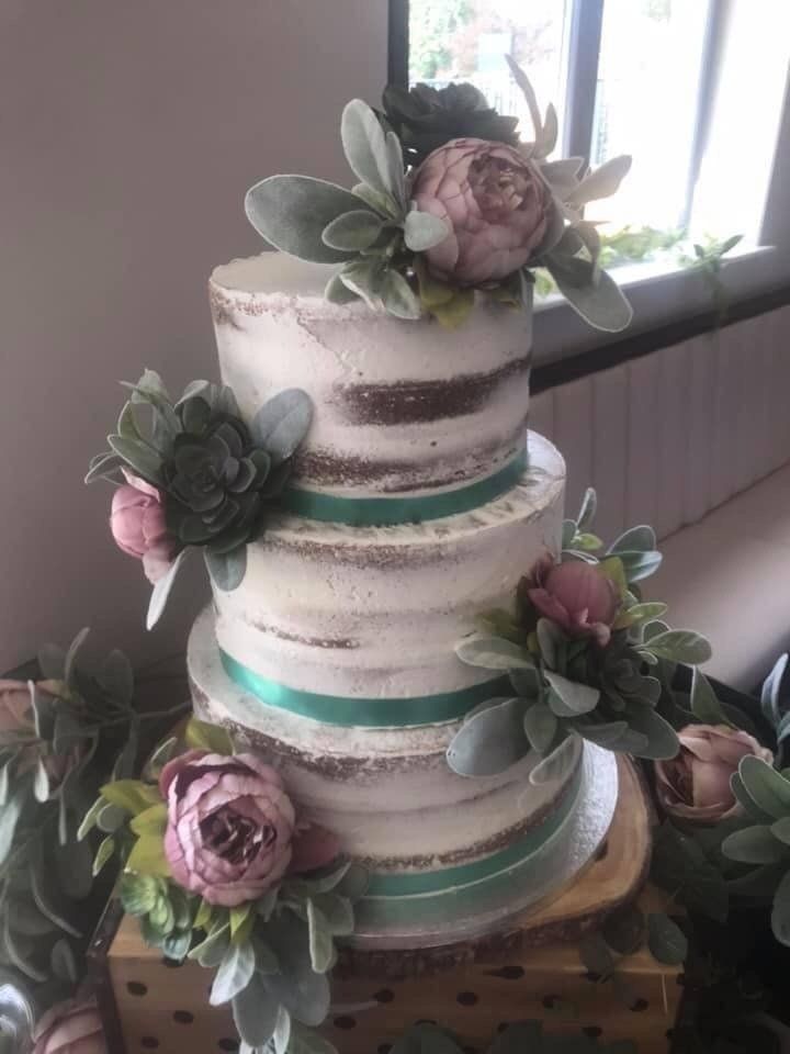 'naked' 3 tier cake with large flowers