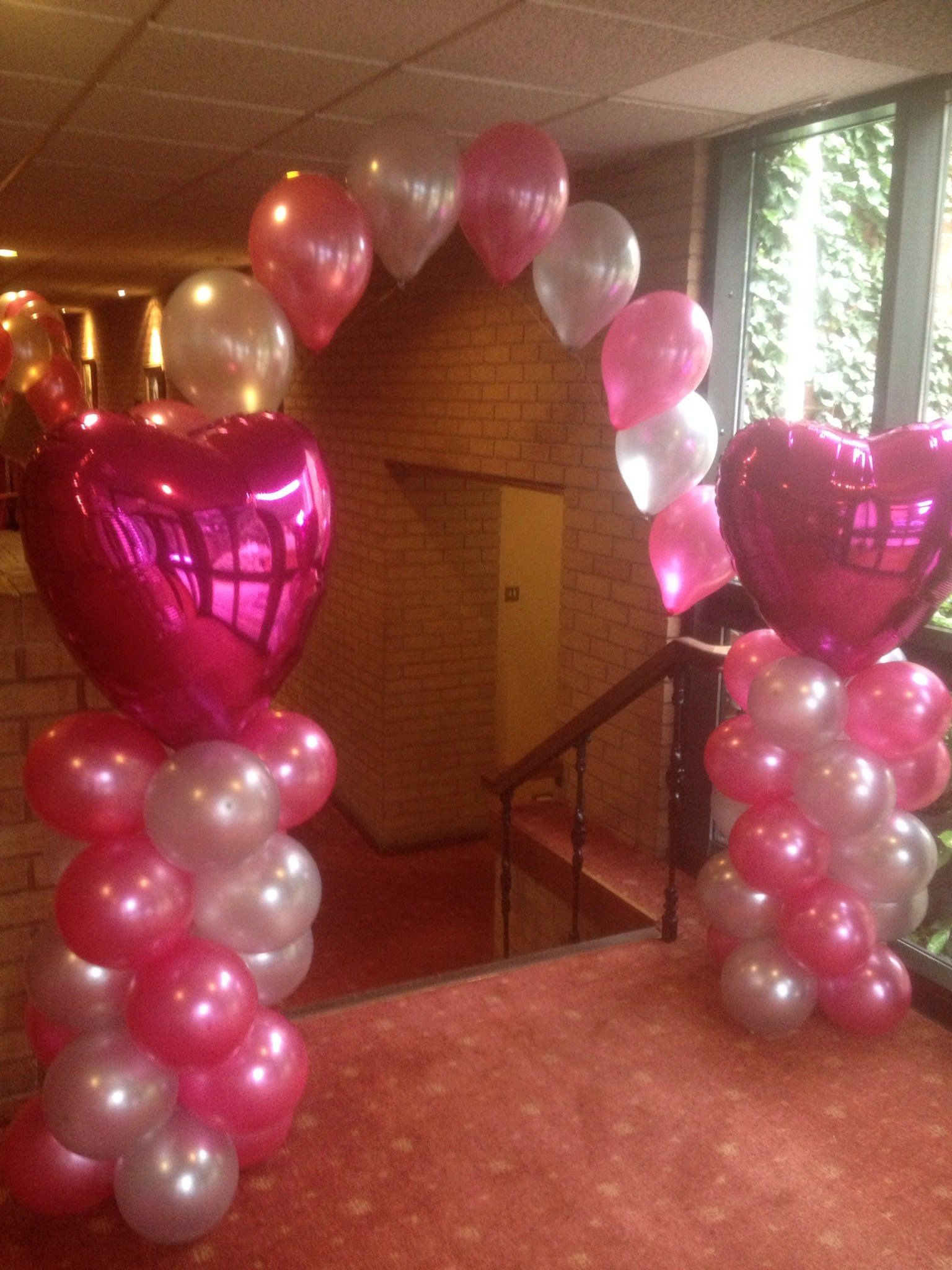 pink and white heart balloon arch