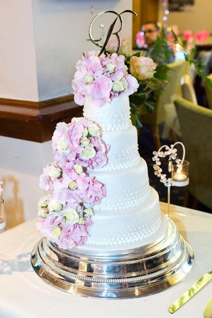 4 tier wedding cake with pink flowers