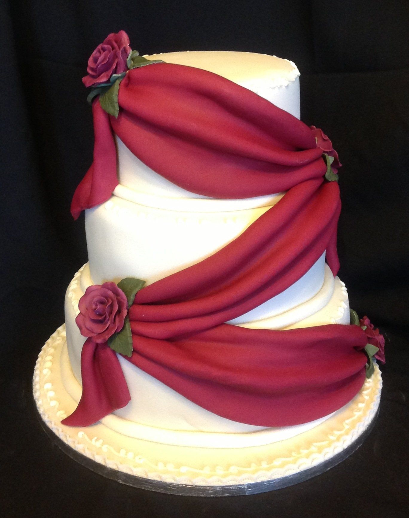 3 tier cake with red sash decoration
