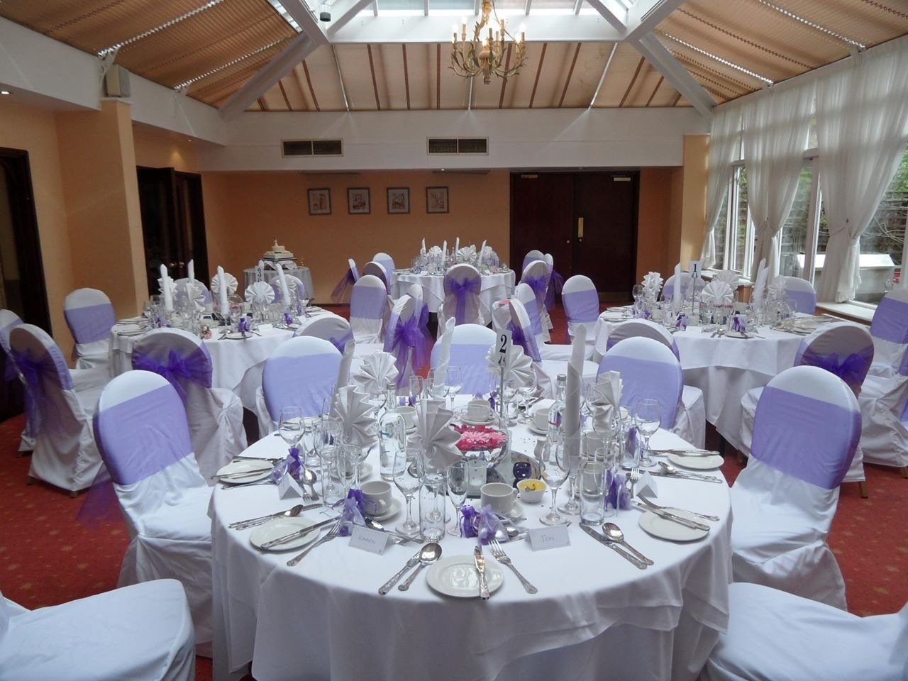 table setting with lilac themed chair covers