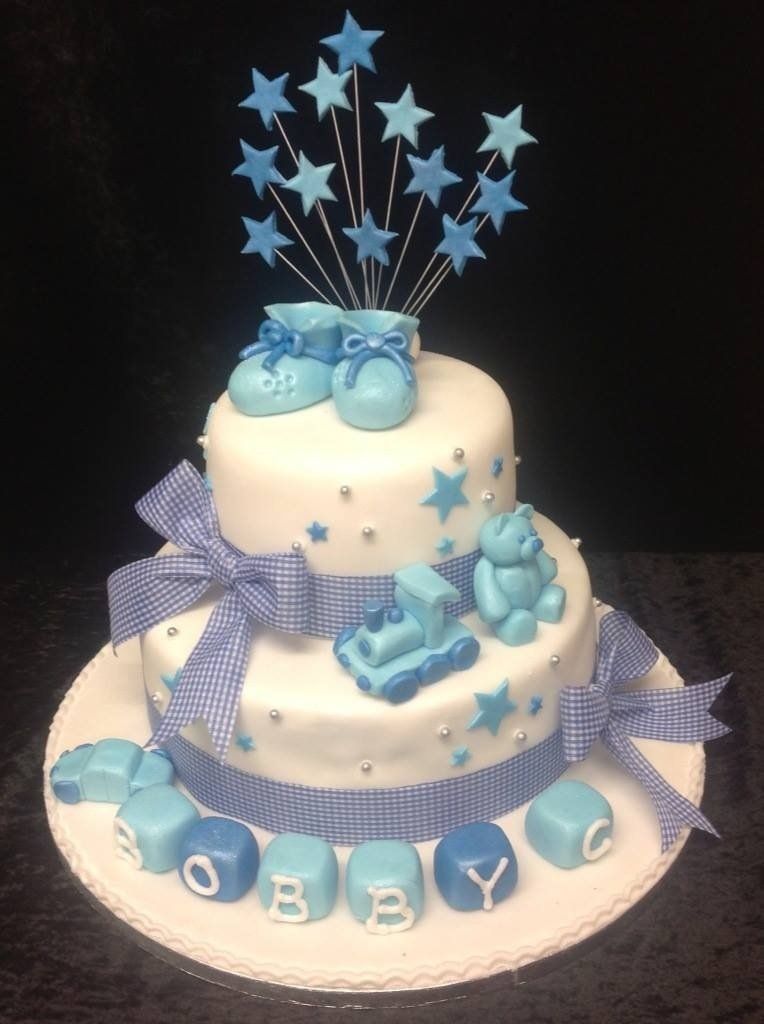 birthday cake with blue booties and toys