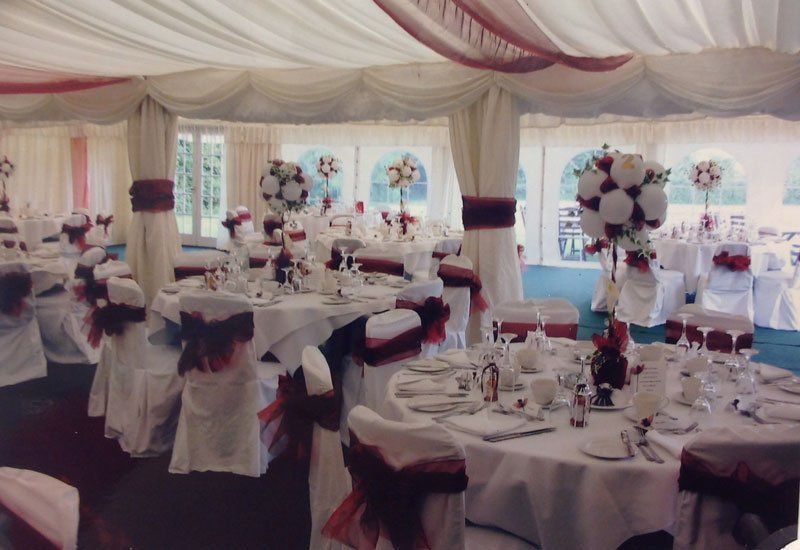 table settings with chairs with red bows