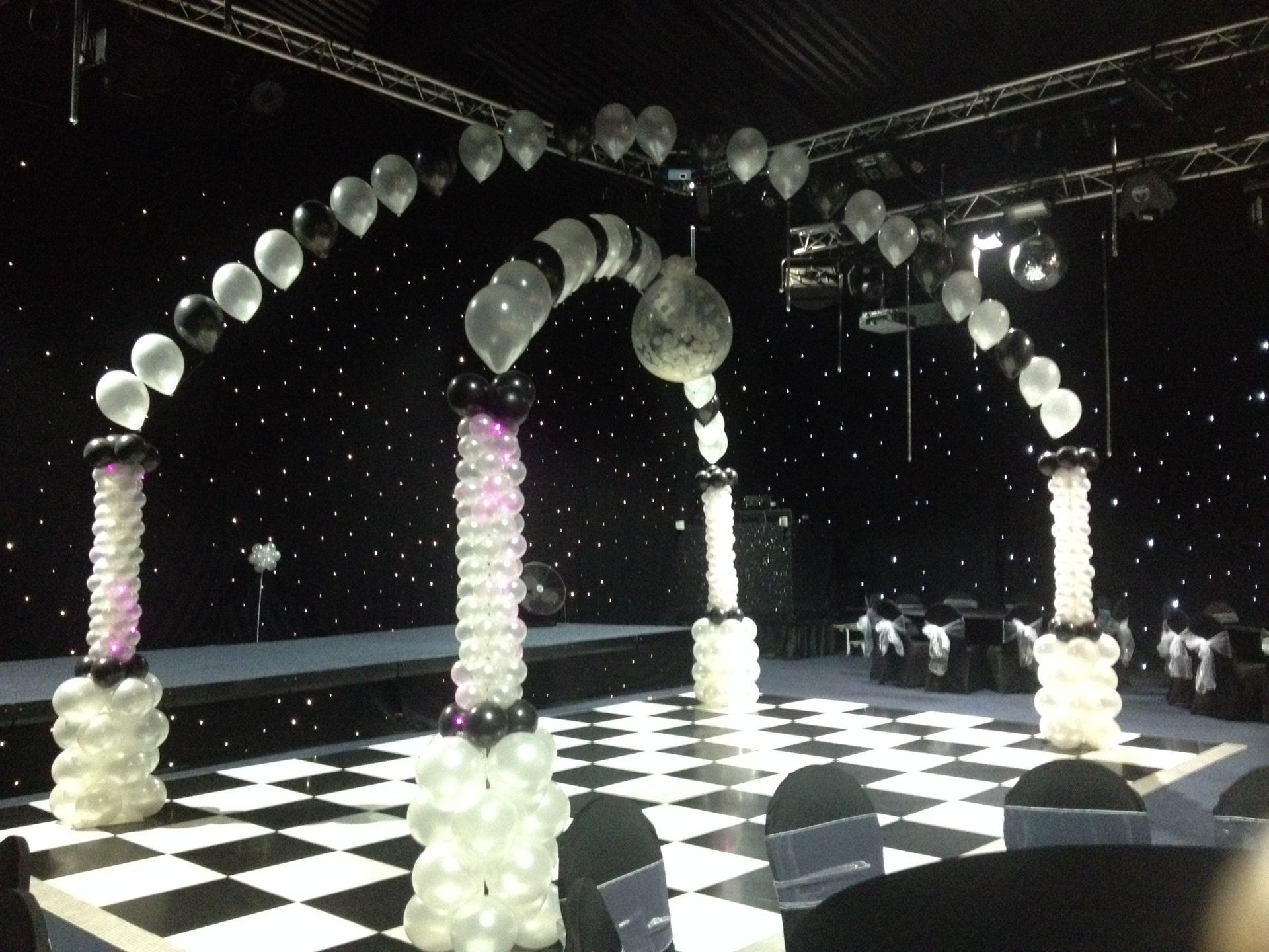 black and white balloons over a chequered dance floor