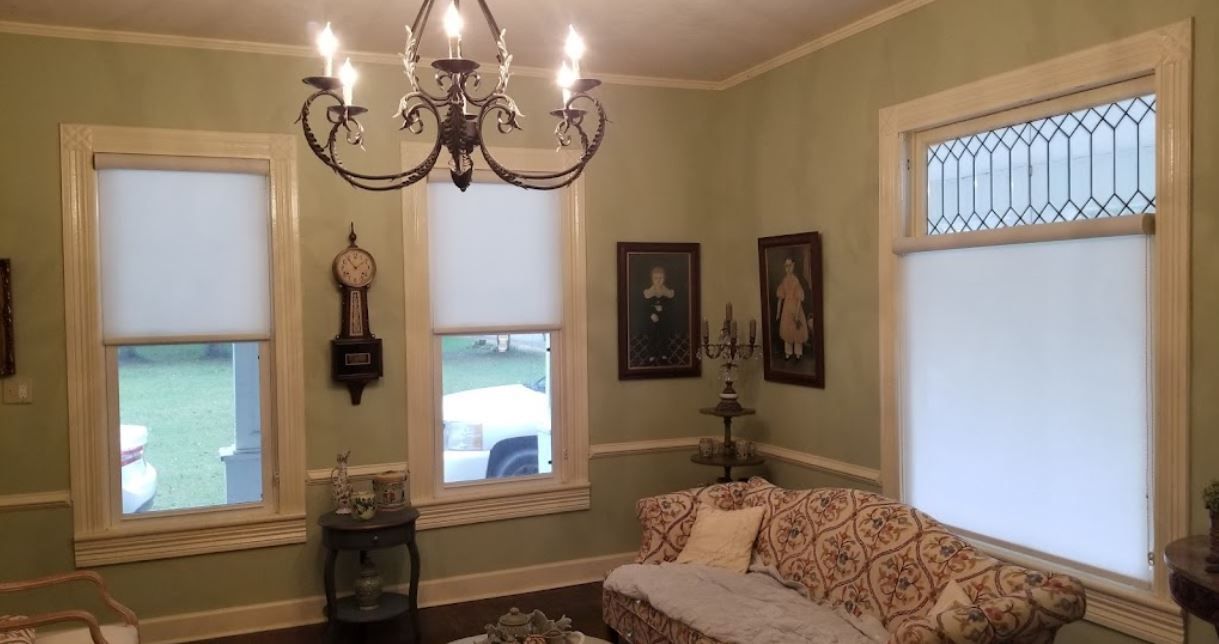 A living room with a couch and a chandelier