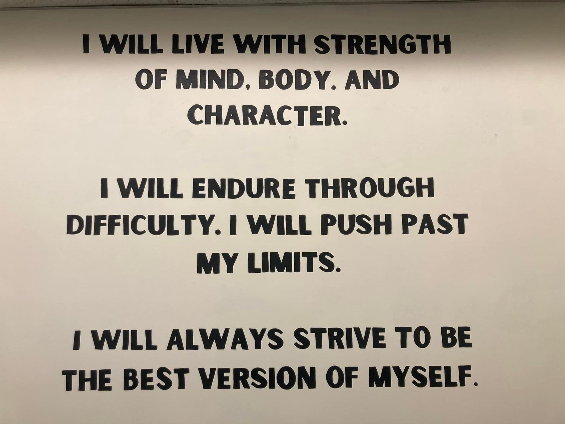 A sign that says i will live with strength of mind body and character