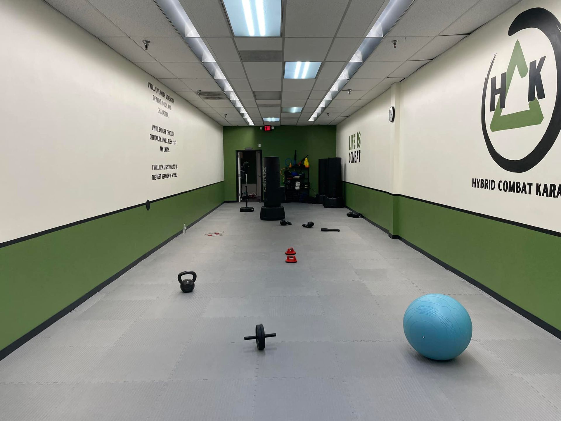 An empty gym with a blue ball on the floor