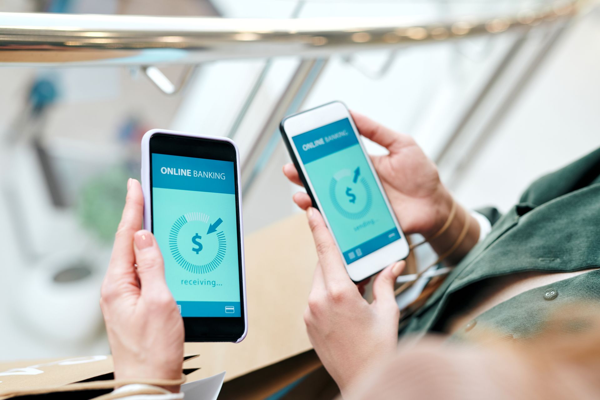 A person is holding two cell phones in their hands.