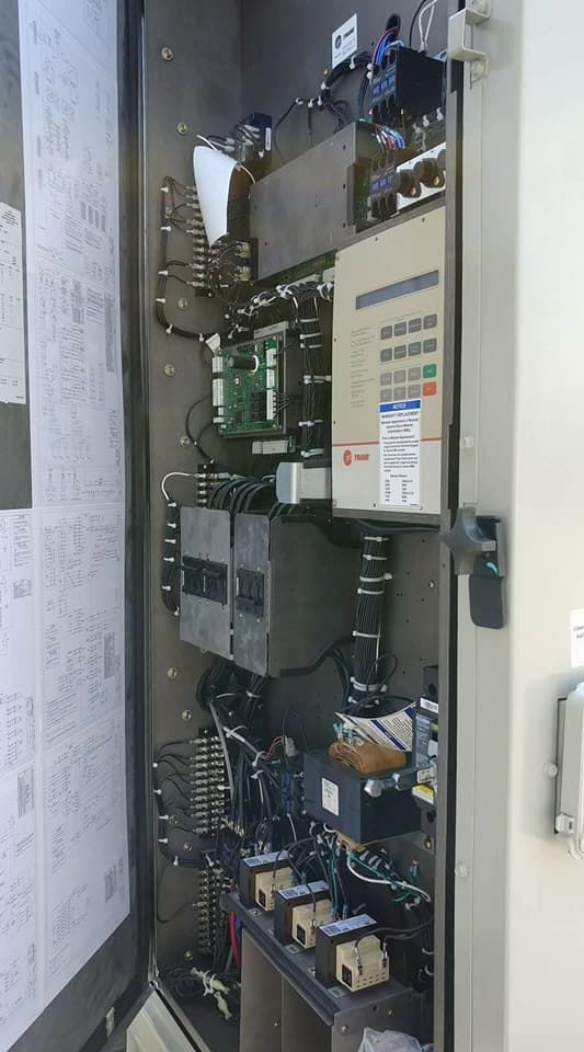 A very large electrical box with a lot of wires coming out of it.