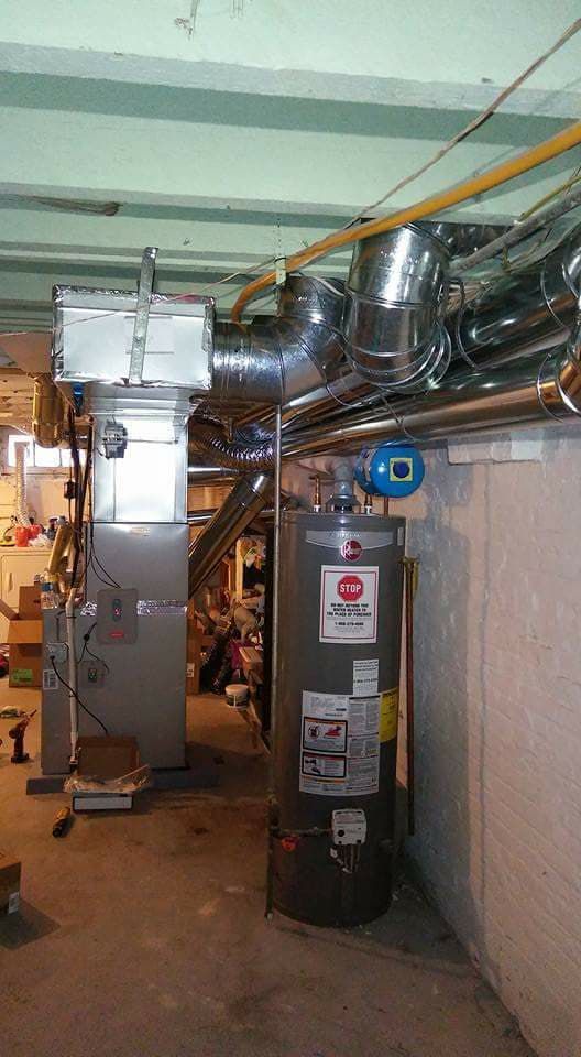 There is a water heater in the middle of the room.