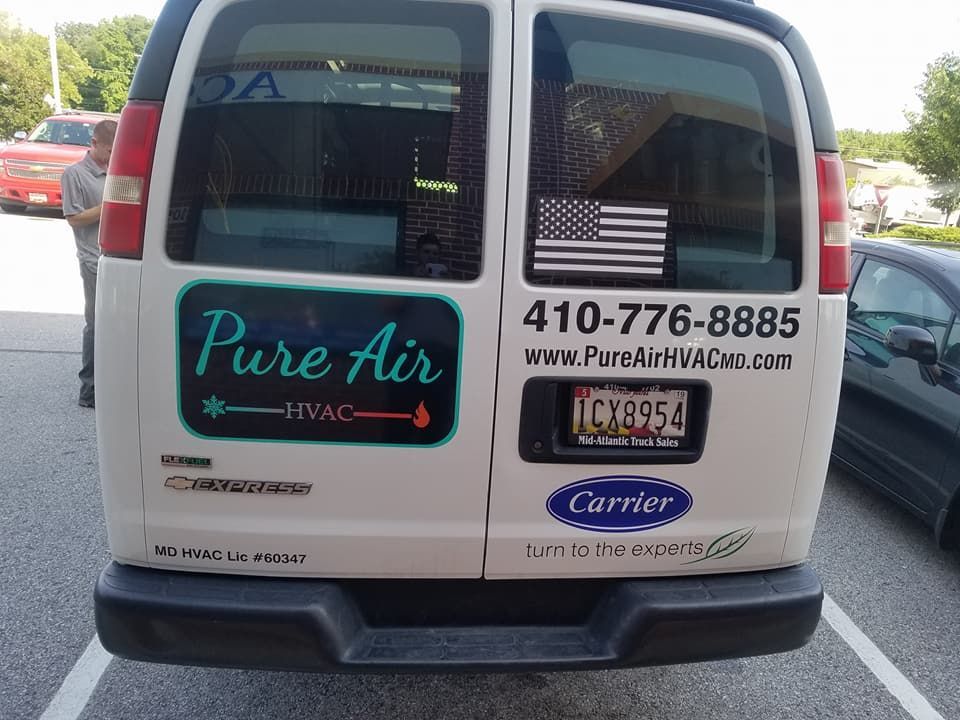 A white van with the word pure air on it