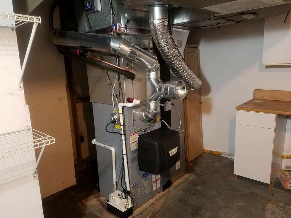 A heating and cooling system is installed in a basement.